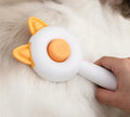 Self-cleaning pet hair remover comb for cats and dogs in greenish white and orange white