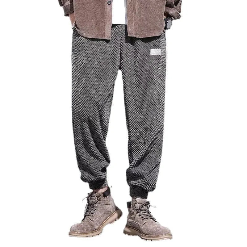 Men's grey straight-leg sweatpants with ankle ties on a plain background.