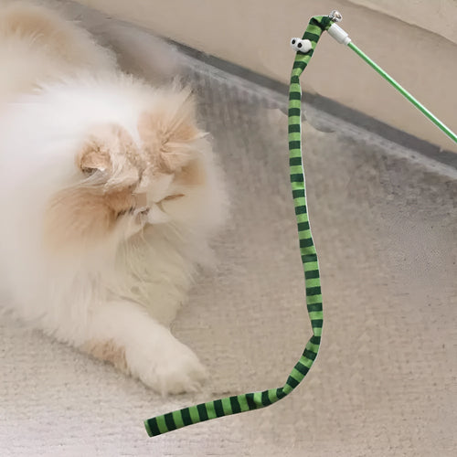 Colourful cat teaser wand with a long plush strip and a bell, held by a person.