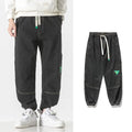 Men's cotton loose-fit tapered trousers in black, blue, or grey with mid-waist design