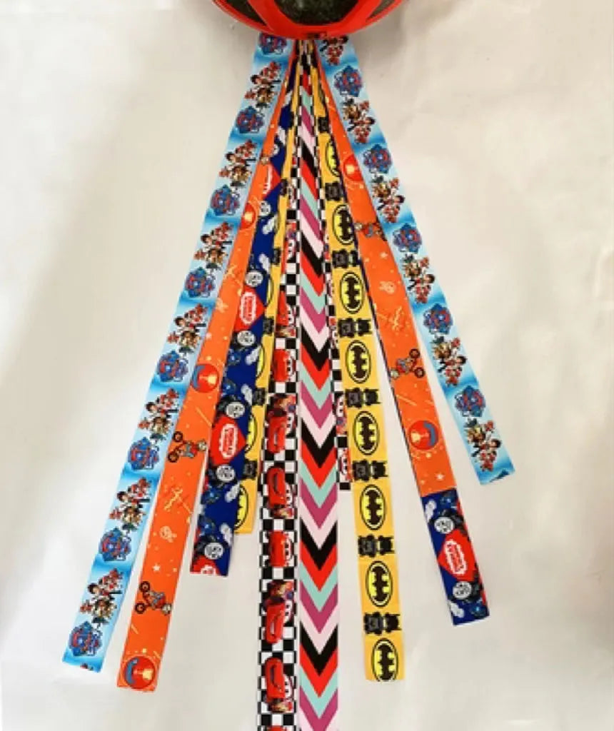A colourful helmet streamer accessory for children's sports helmets and doll decoration.