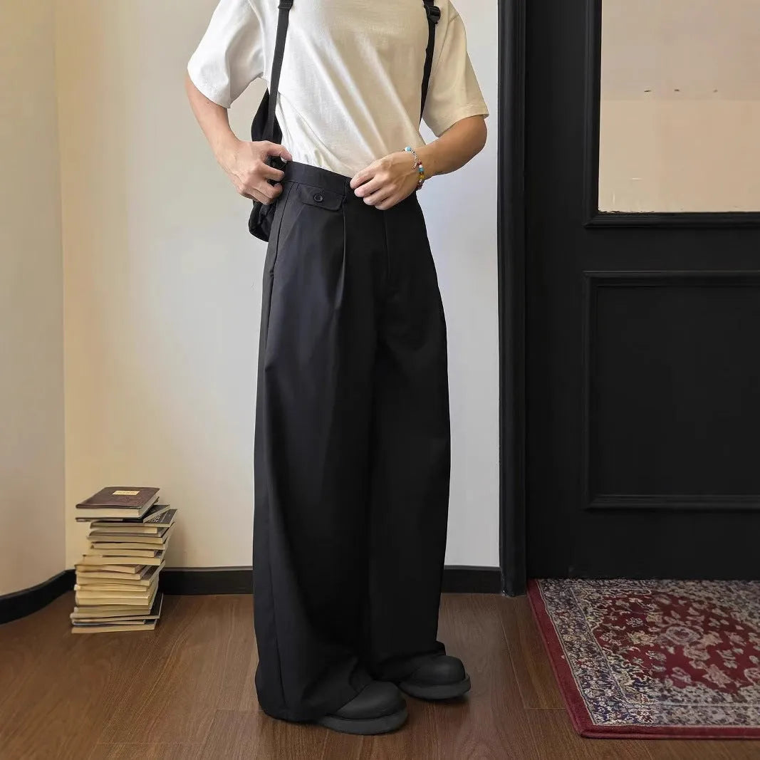 Men's straight-leg loose-fit trousers in brown and black colours on a hanger.