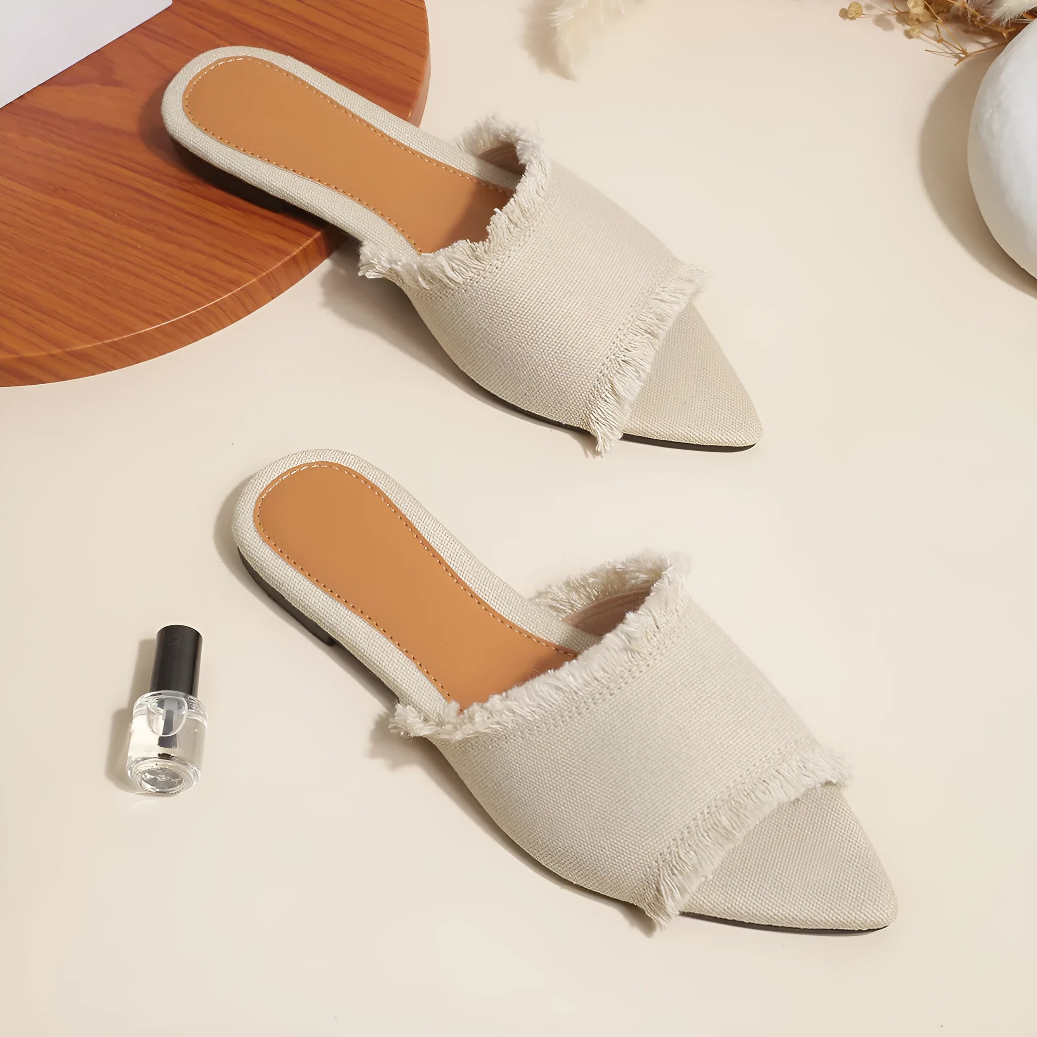 Women's denim flat slippers with a tassel, leather lining, and a PVC sole in various colours.