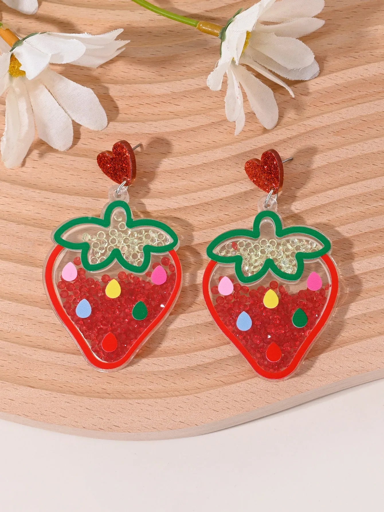 Colourful acrylic fruit and ice cream dangle earrings for women on a white background.
