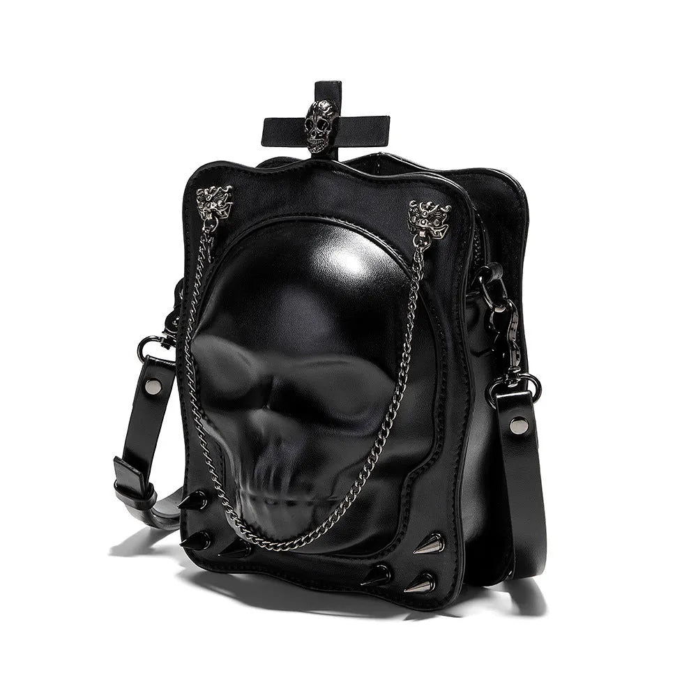 Black mini square crossbody bag with 3D embossed skull design, stitching details, and metal rivets