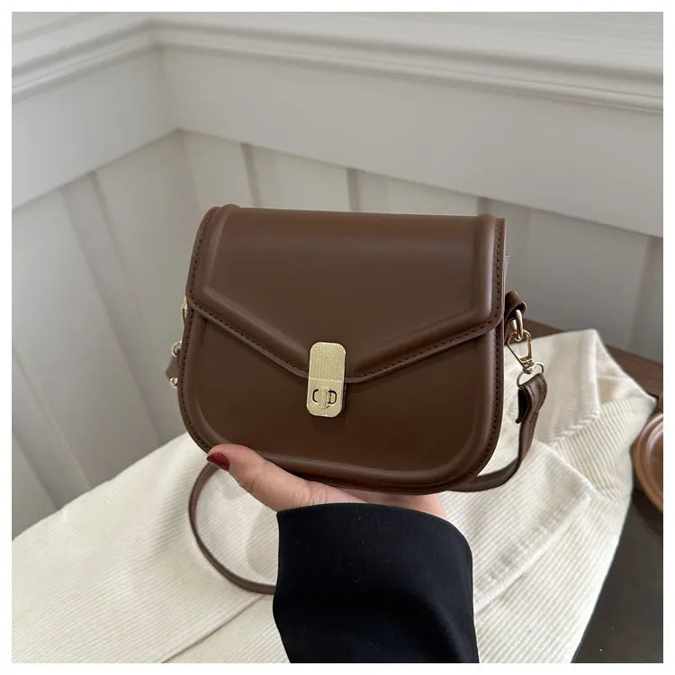 Soft PU leather horizontal square messenger bag with clamshell opening in khaki colour.