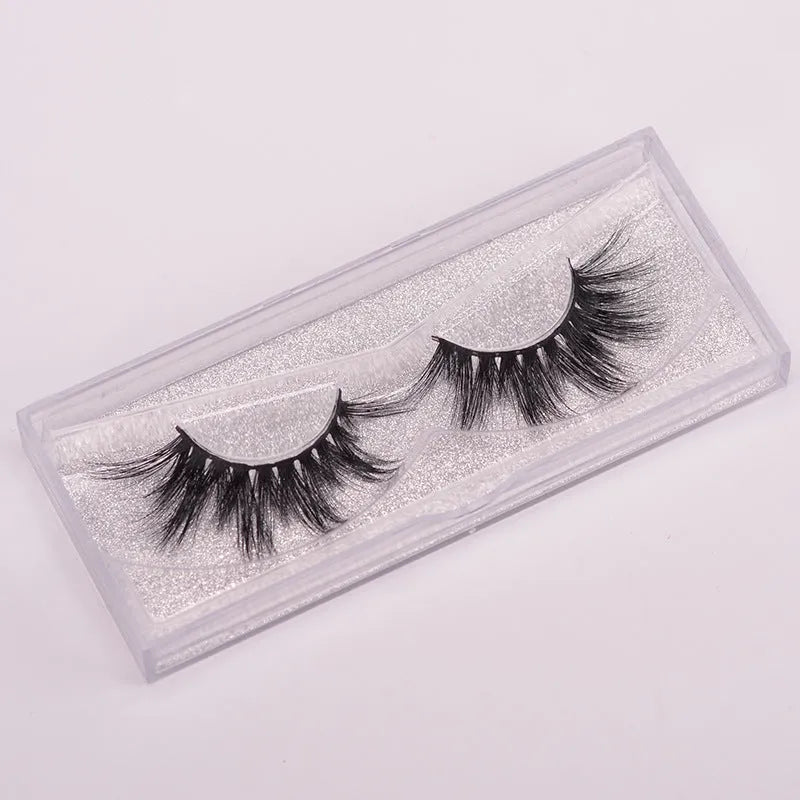 Handmade 5D volume false eyelashes made from mink hair with a storage case and application brush.