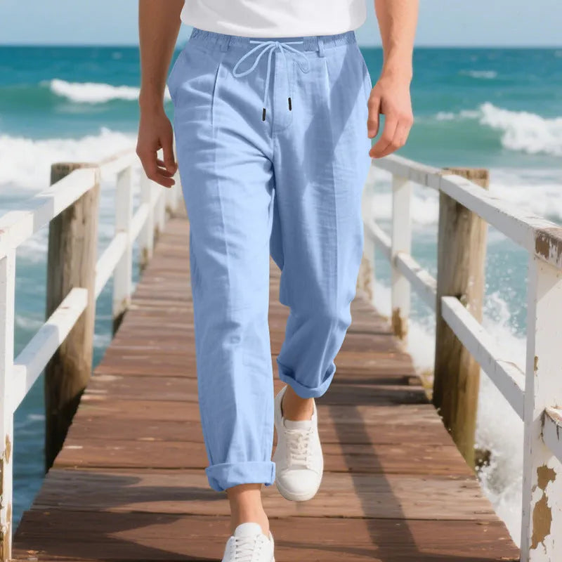 Men's light khaki linen casual trousers with a drawstring waist and straight-leg fit on a hanger.