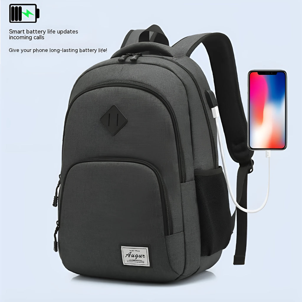 Gray nylon backpack with USB charging port and trolley sleeve on a suitcase.
