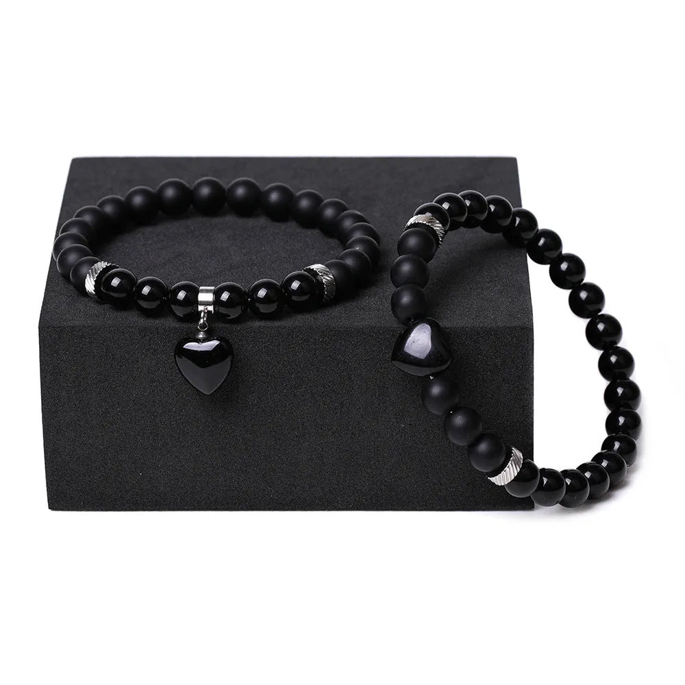 Natural stone couple bracelet set showing two matching bracelets with heart-shaped polished stone charms