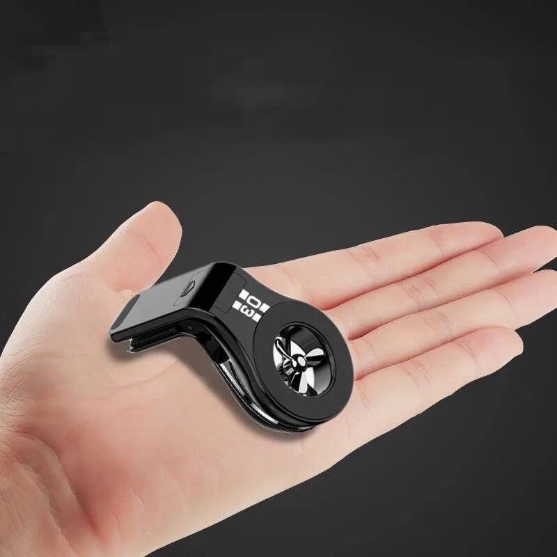 Black universal magnetic car phone holder clipped to a car air vent, holding a smartphone.