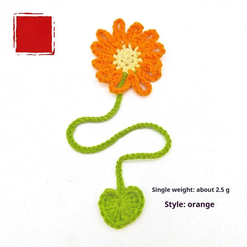Hand-crocheted wool bookmark with flexible wire core and little daisy design in milk cotton yarn