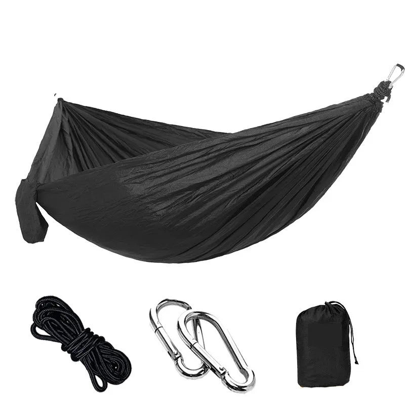 Double camping hammock with ropes and buckles shown in outdoor setting