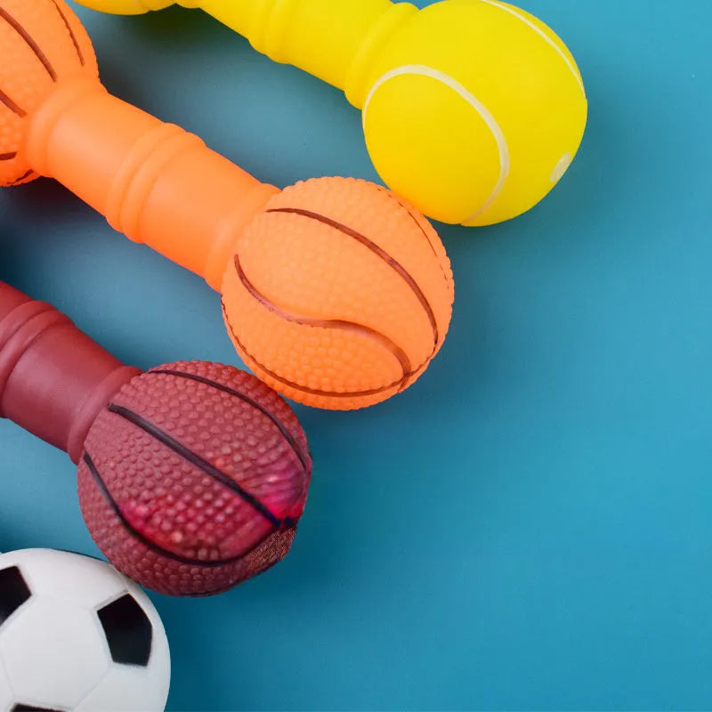 Brown orange white yellow PVC football dumbbell shaped squeaky dog chew toy on a plain background.