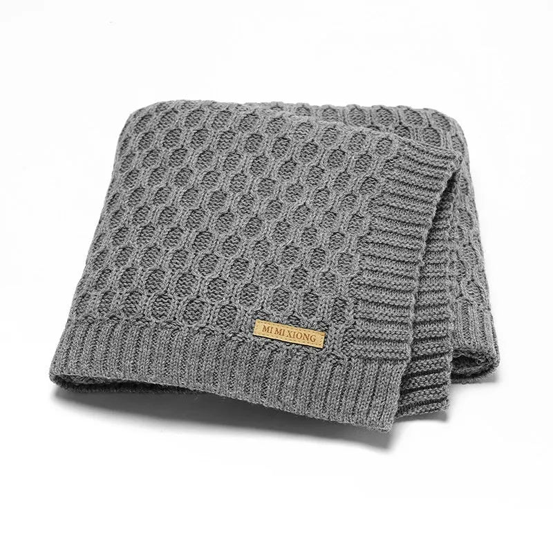 Solid colour acrylic infant hug blanket with textured lines, shown in beige khaki colour.