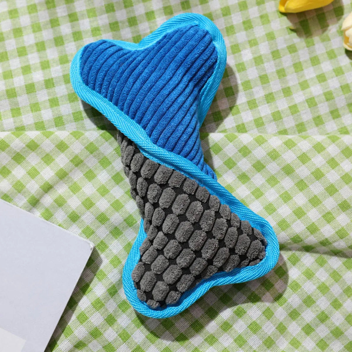 Blue plush teddy dog toy with a squeaker bone inside and soft corn fleece lining