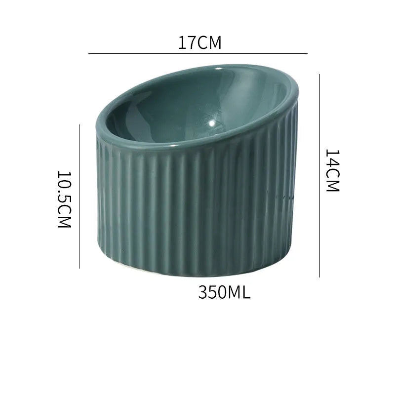 Dark green ceramic elevated cat bowl with tilted design on a wooden surface.