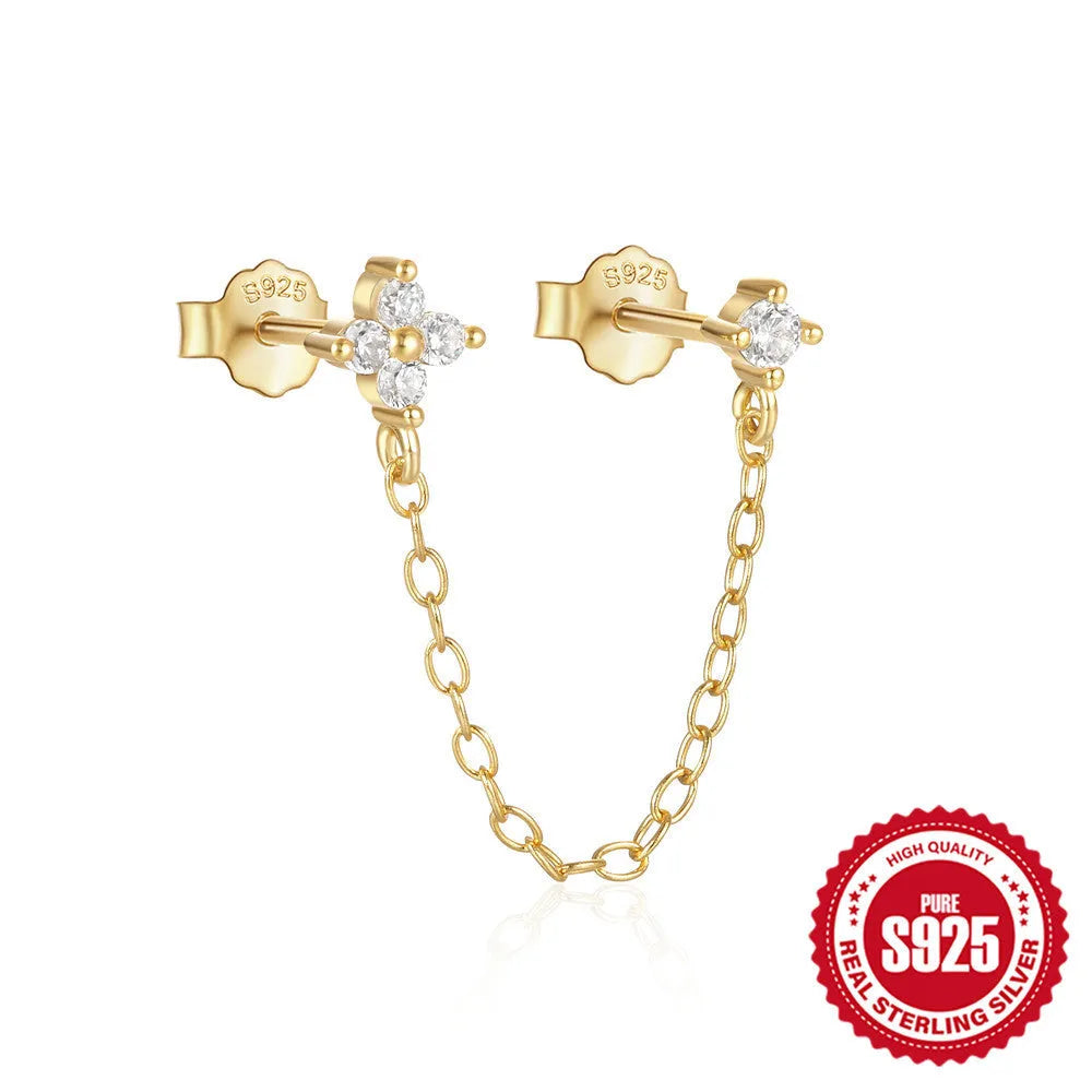 Close-up of a women's S925 sterling silver stud earring with a diamond flower, chain, and tassel design in a gold colour.
