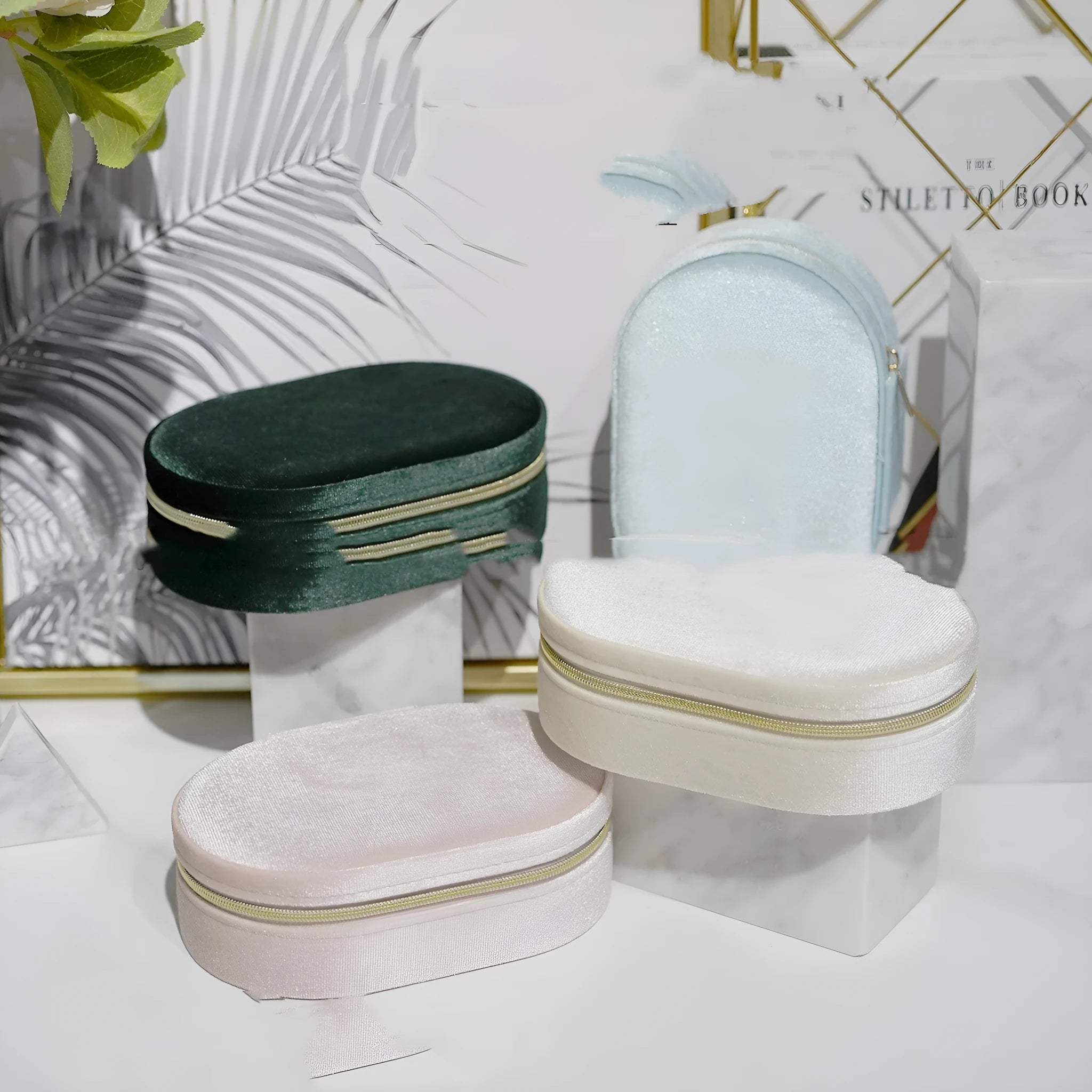 Oval velvet jewellery storage box in lake blue colour with flannel lining, shown with internal hook