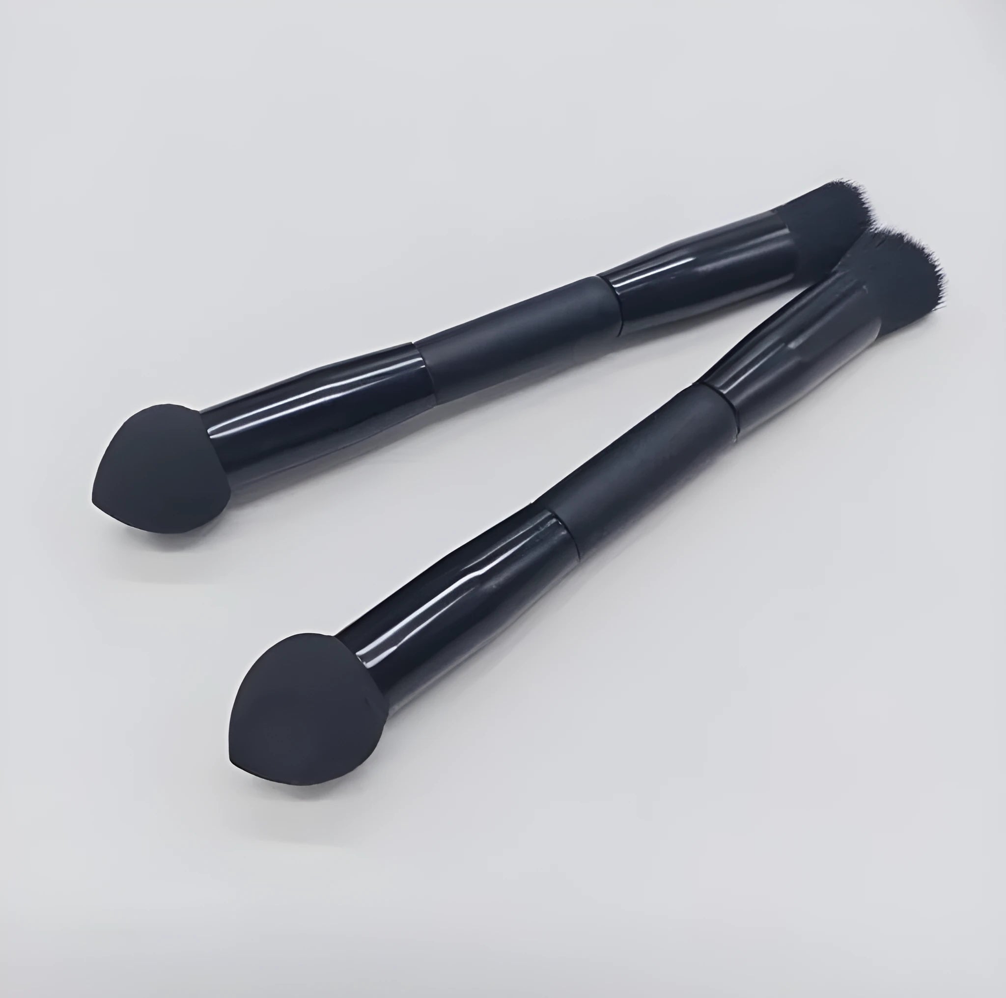 Elegant black double-headed concealer brush with sponge tip and artificial fibre bristles