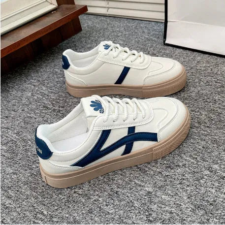 Low top blue board shoes with round toe and flat rubber sole on white background