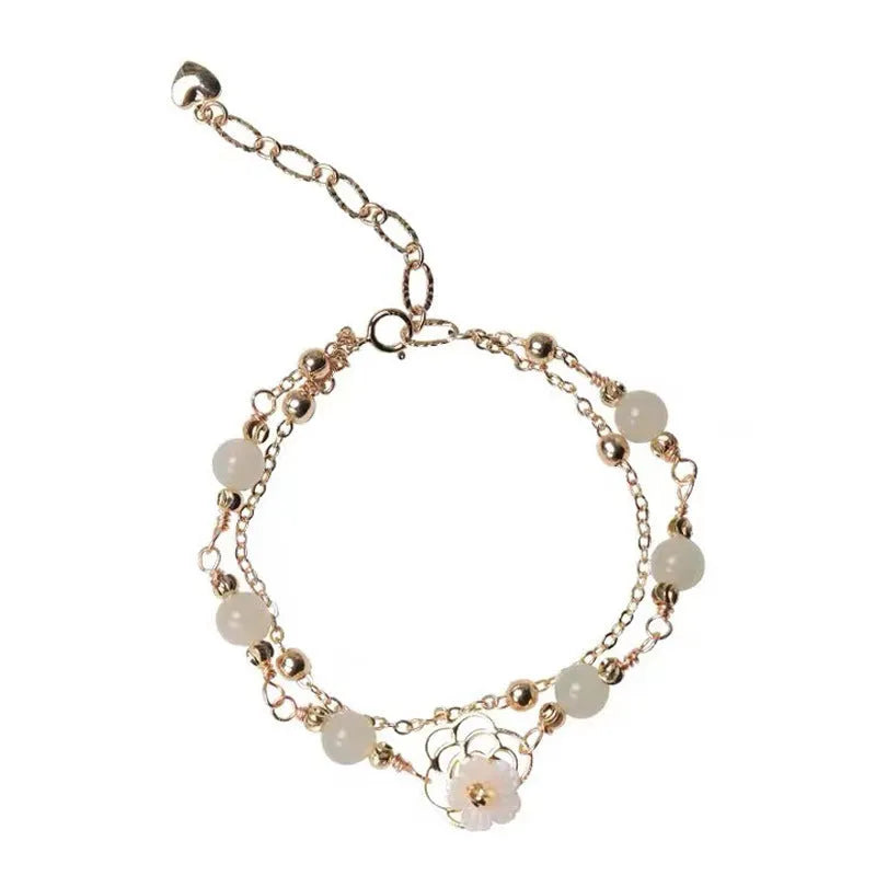 Yellow gold shell flower butterfly bracelet for women with geometric shape and bells of Ireland design