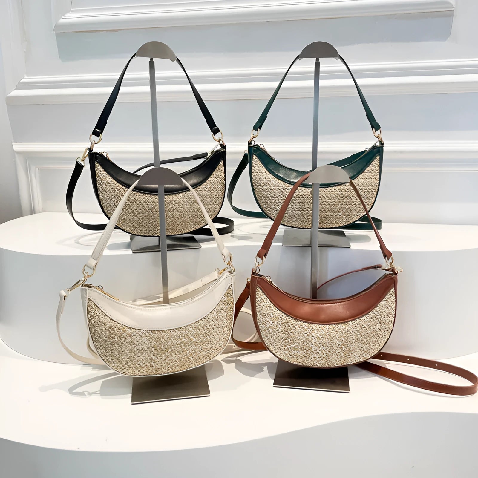 Hard structured straw dumpling shaped women's crossbody shoulder bag in black with contrast stitching.