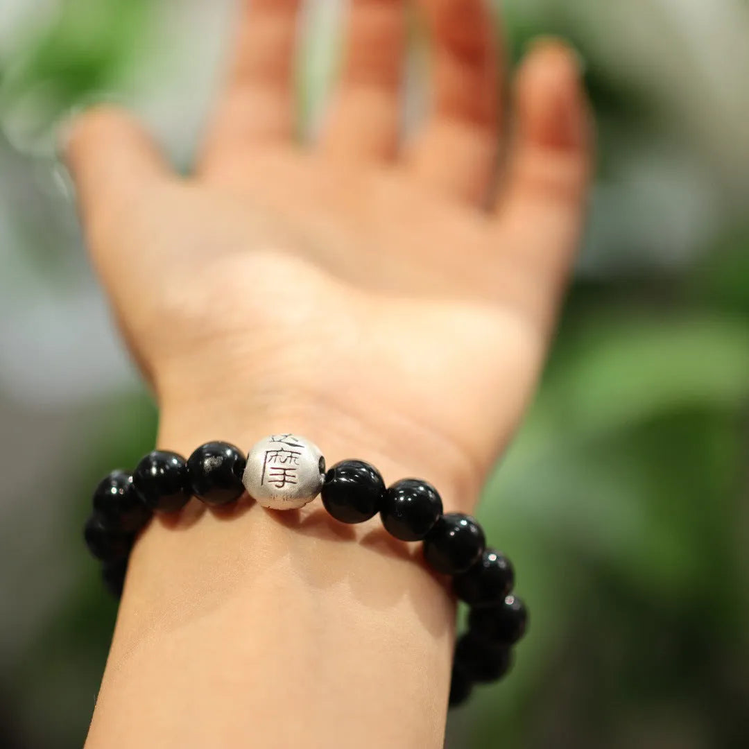 Black agate bracelet with 10mm beads and sterling silver clasp on wrist