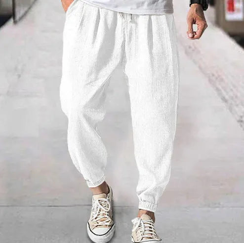 Men's casual cotton trousers with banded ankles in light green colour showing loose fit summer style