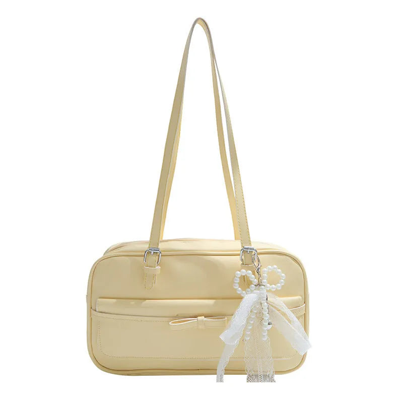Single-shoulder flap bag in horizontal square shape with bow decoration and internal phone compartment