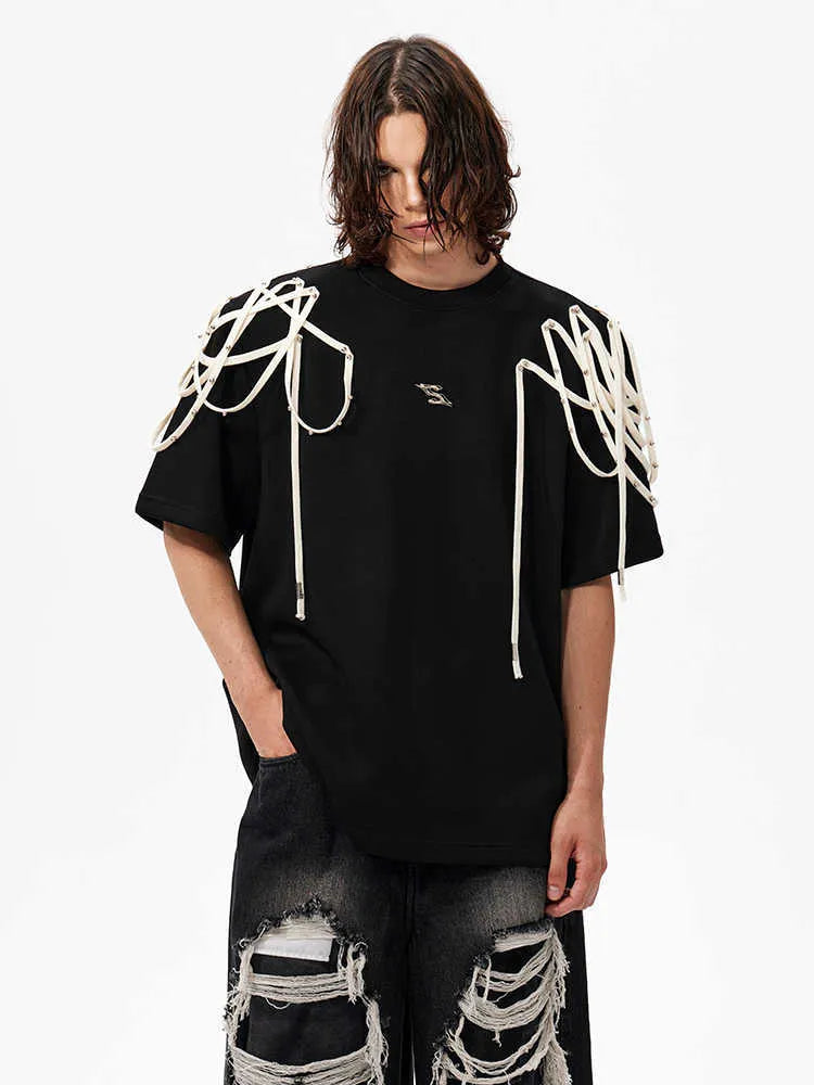 Black loose-fit T-shirt with padded shoulders featuring rivet ribbon detail, short sleeves, and round neck