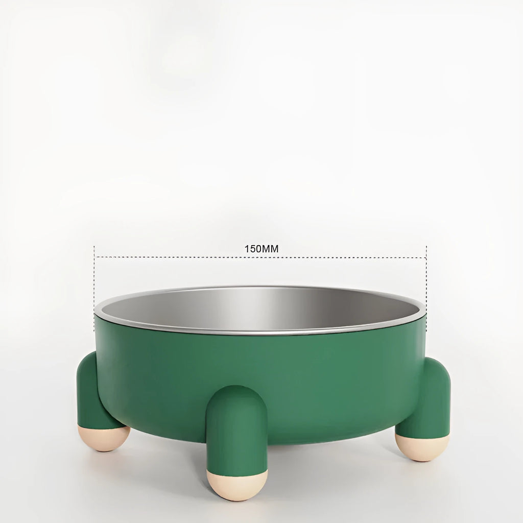Green stainless steel pet bowl with a high foot and non-slip base on a kitchen floor.