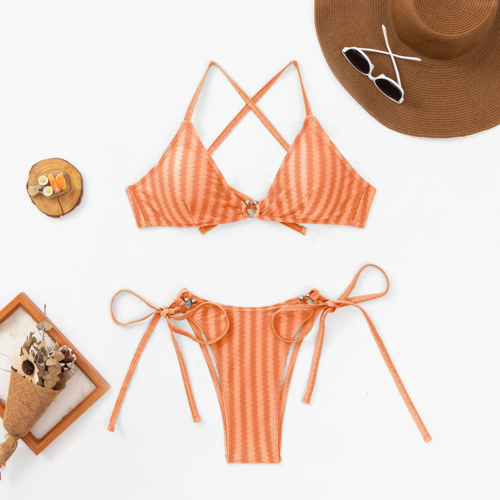 Women's red lace-up bikini set with backless design on a mannequin.