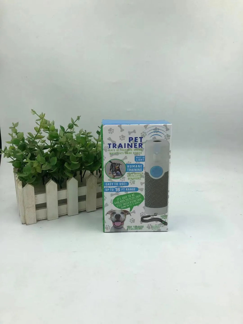 White handheld ultrasonic dog trainer bark stop device on a plain background.