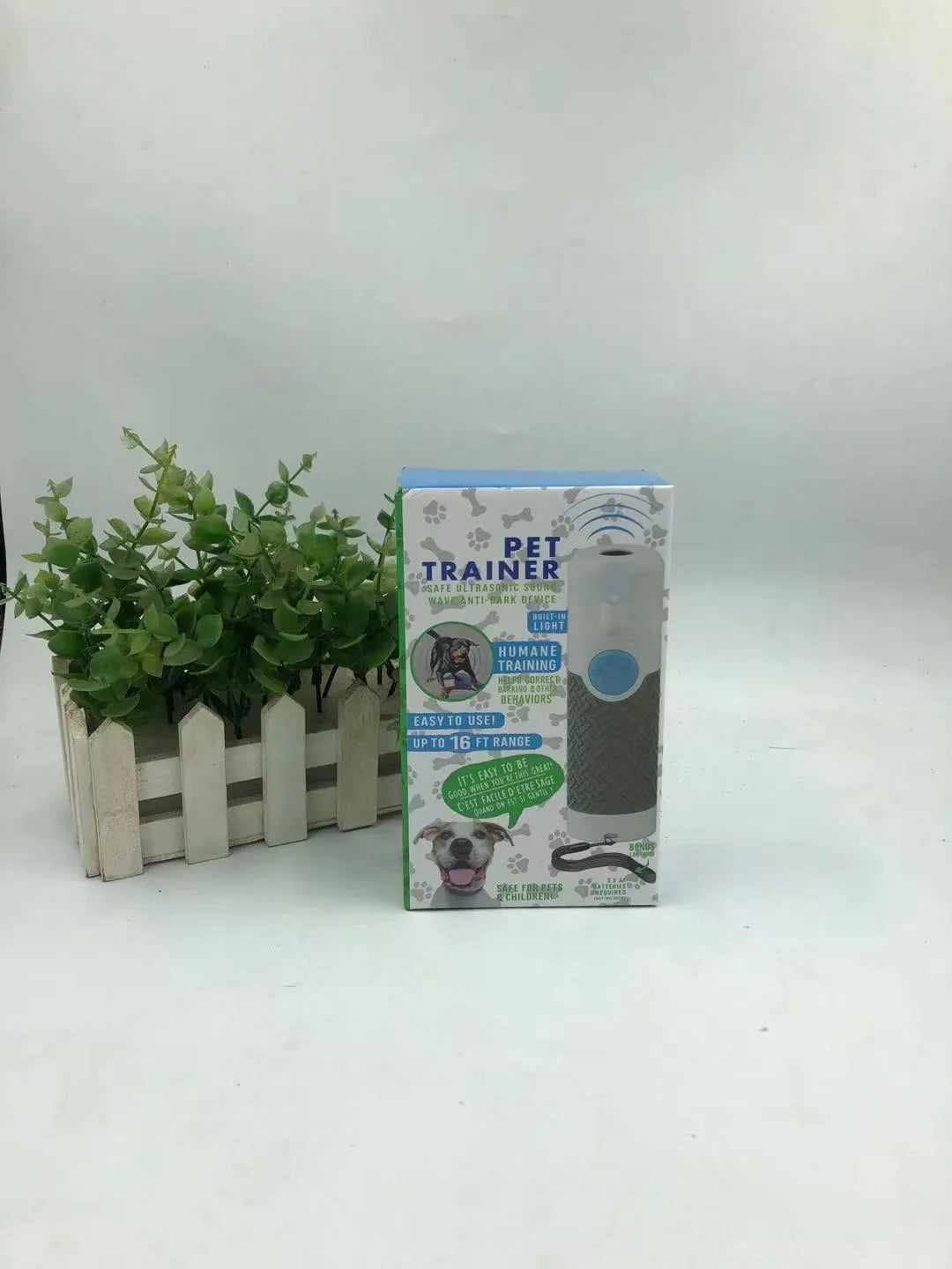 White handheld ultrasonic dog trainer bark stop device on a plain background.