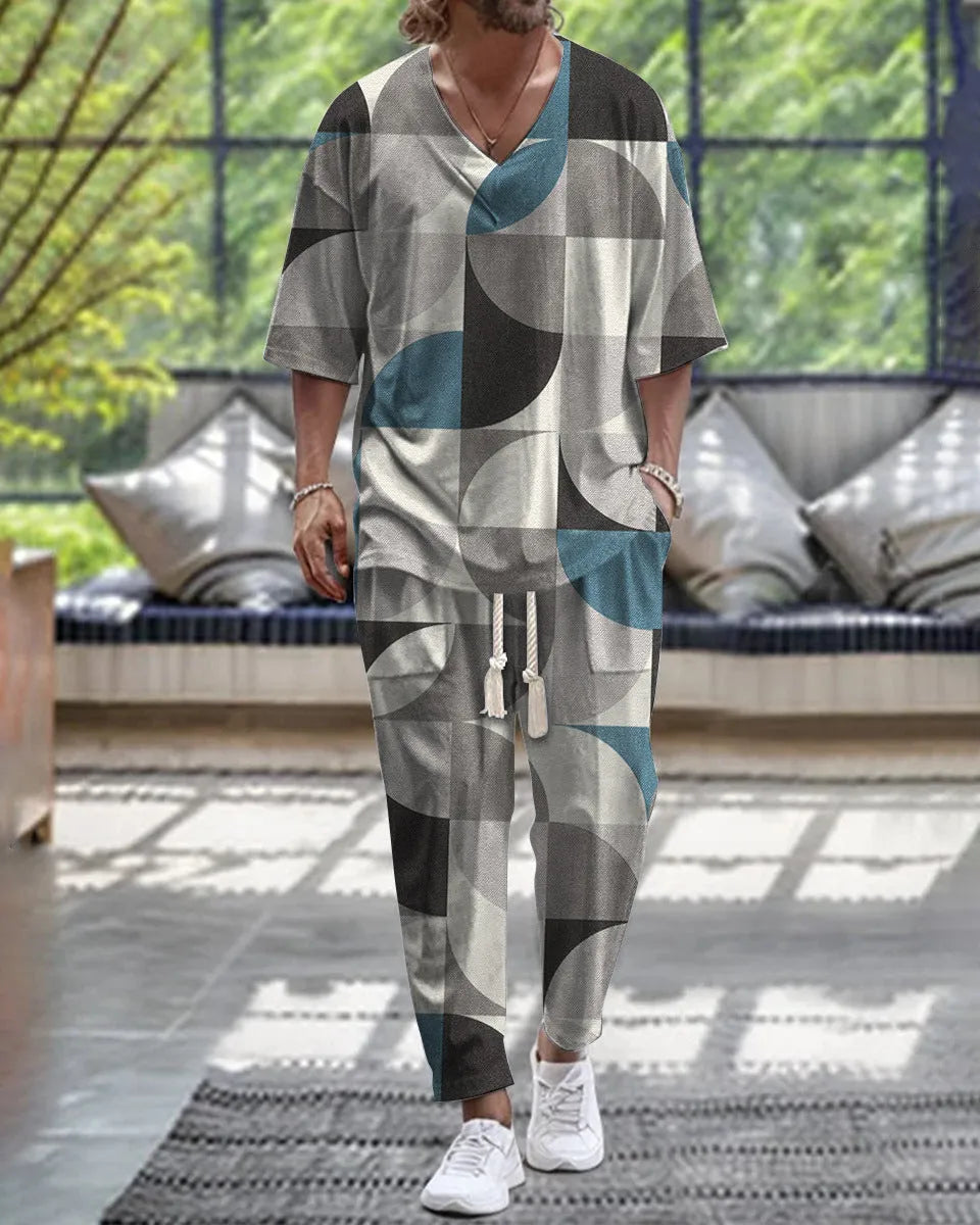 Thin polyester trousers suit with V-neck cropped sleeve jacket and matching trousers on a hanger.