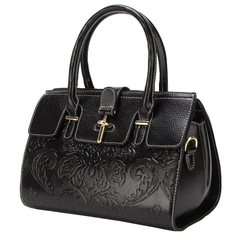 Genuine leather vintage embossed women's crossbody bag in black showing laptop compartment interior