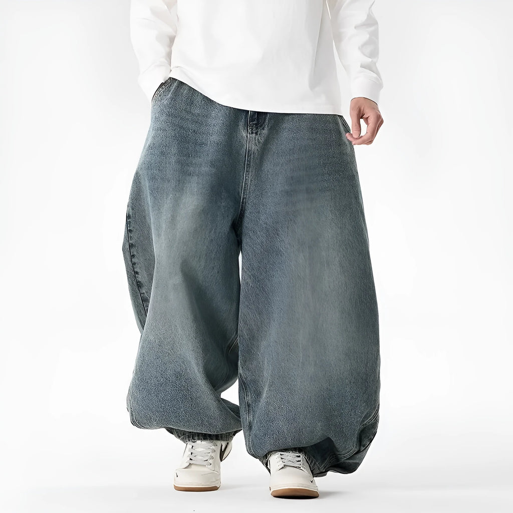 Men's plus size baggy wide leg jeans in light blue denim laid flat