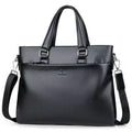 Men's black and brown PU leather business messenger bag with splicing design on a table.