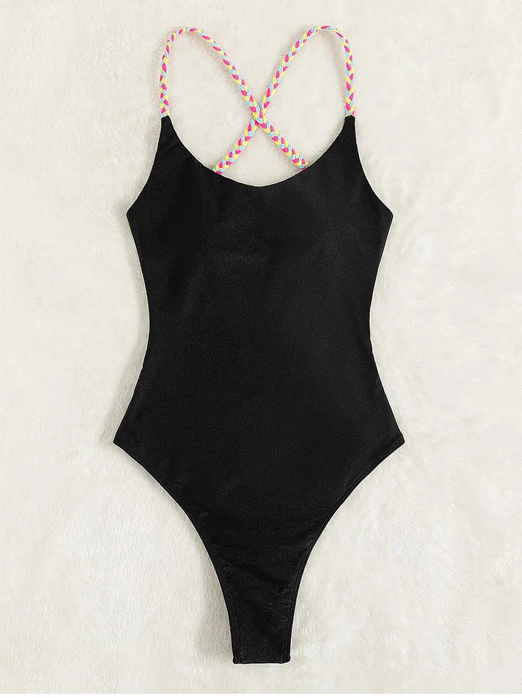 Black women's one-piece swimsuit with a backless and sleeveless design on a mannequin.