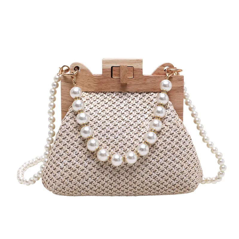 Beige woven straw women's shoulder bag with pearl chain detail, showing interior zipper pockets.