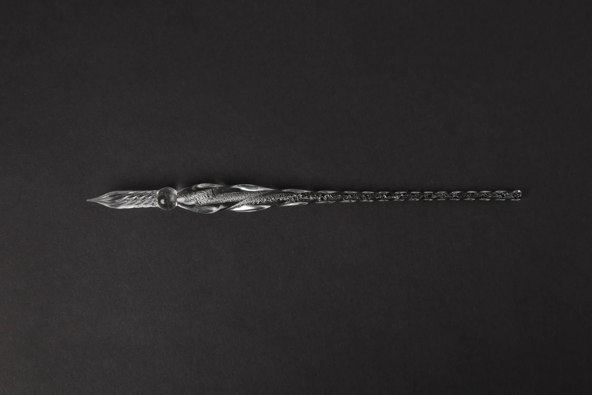 Hand-blown glass crystal pen with coloured ink in a transparent barrel on a gift box.