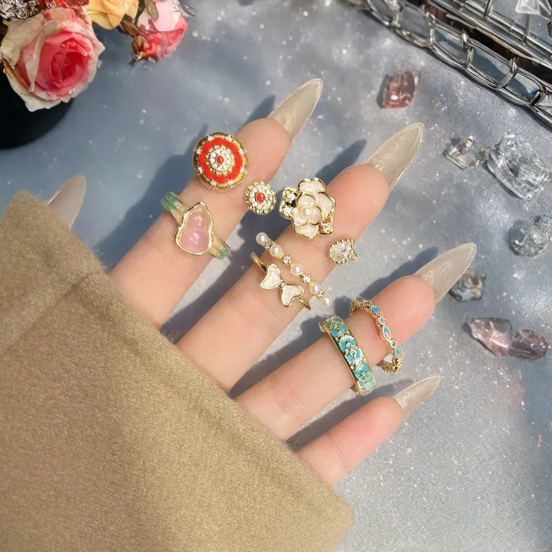 Adjustable Chinese gourd ring with zircon inlay showing floral and bow elements in oil-drip finish