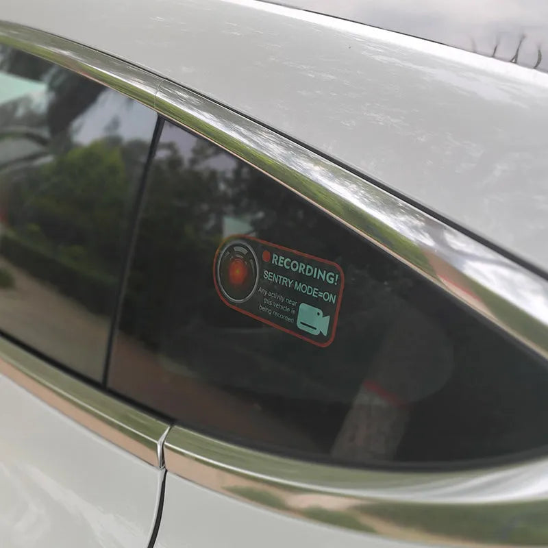 Pair of white rectangular electrostatic warning stickers for Tesla Sentry Mode, measuring 11cm by 5cm.