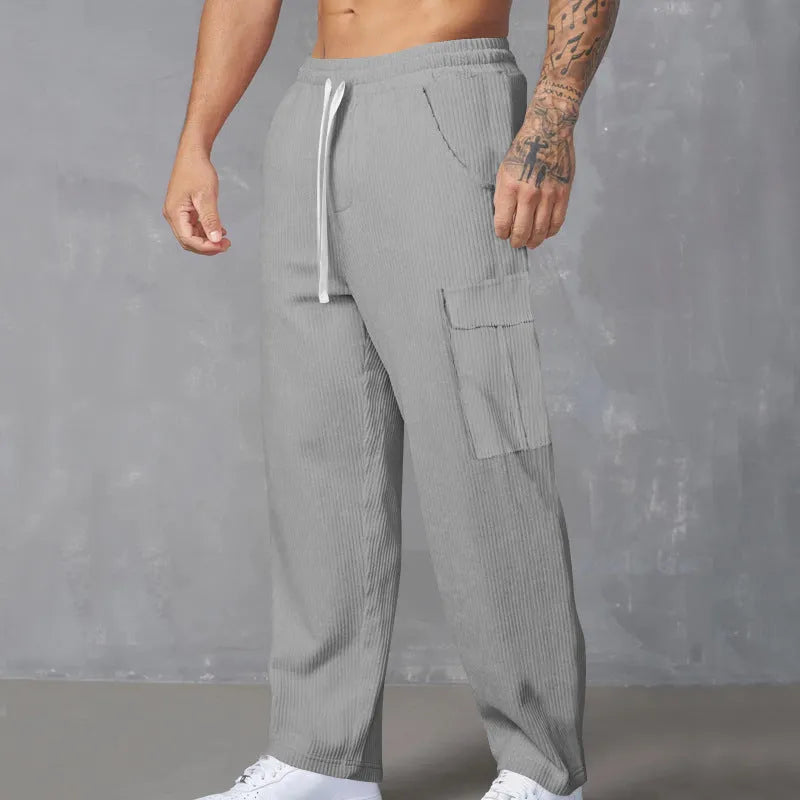 Men's loose-fitting corduroy cargo trousers in navy blue with straight wide-leg cut and elasticated waist