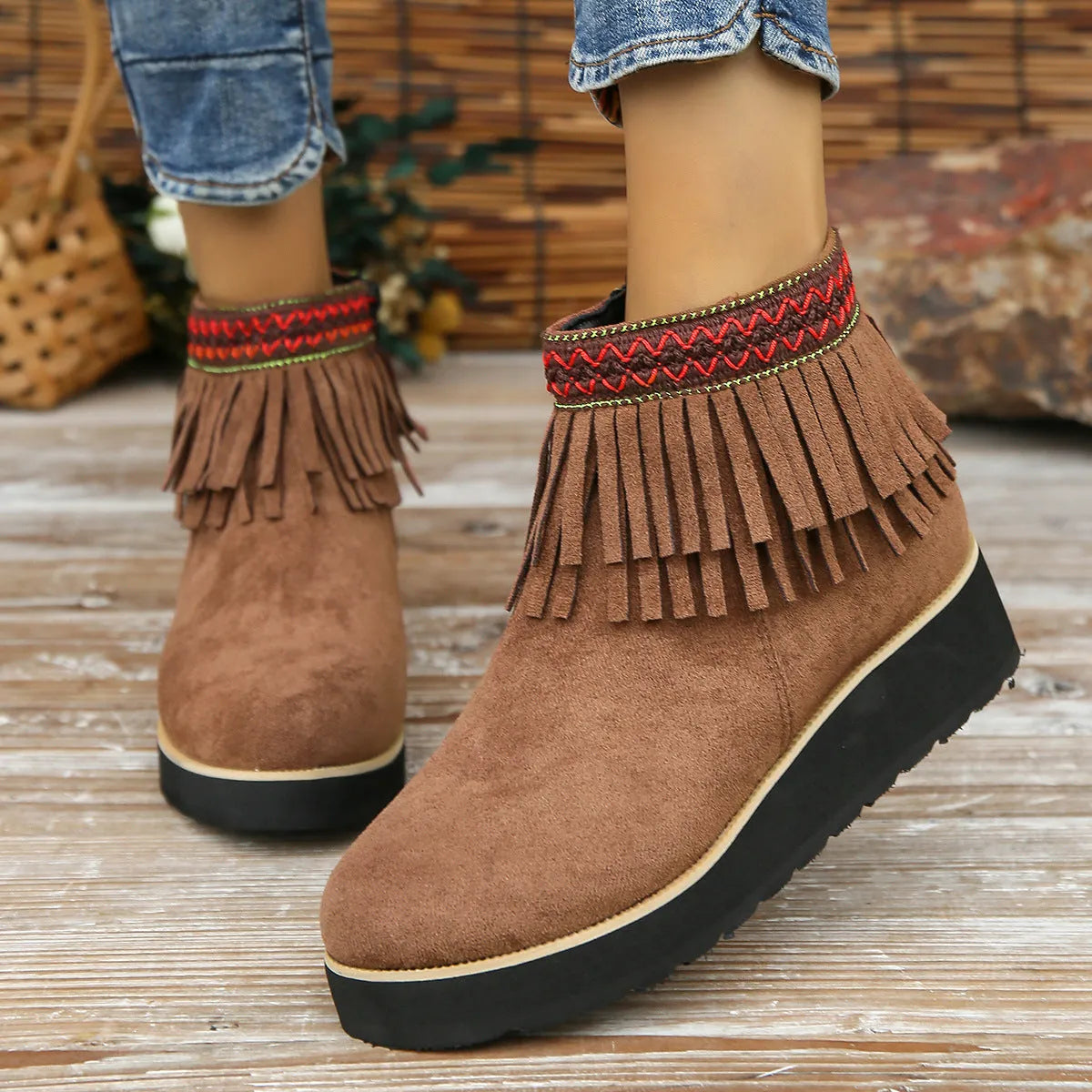 Women's dark brown suede ankle boot with wedge heel, side zipper, and decorative tassel.