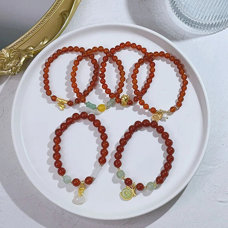 Handmade red agate bracelet with dragon and lucky bag Chinese designs for women.