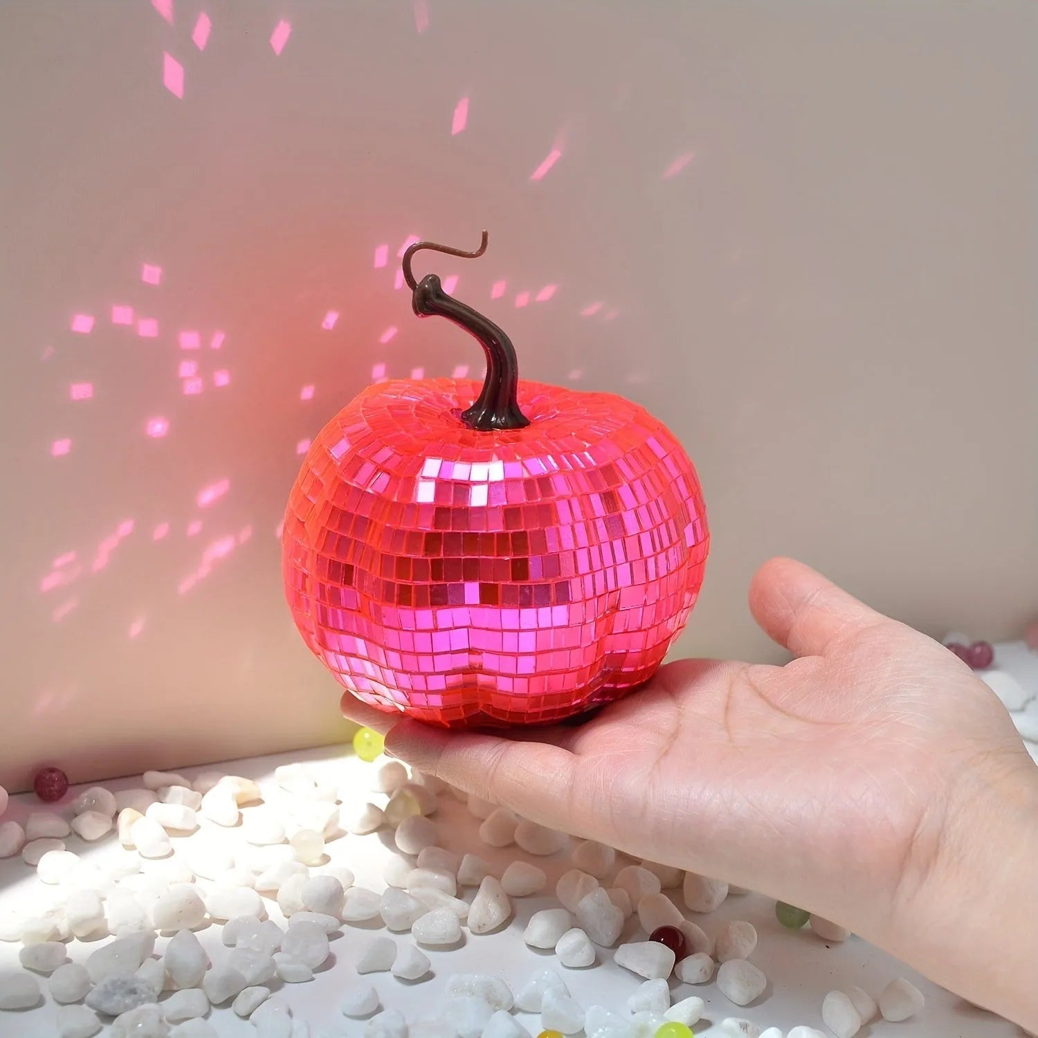 Chinese-style mirror glass pumpkin Halloween decoration in various sizes on a shelf.