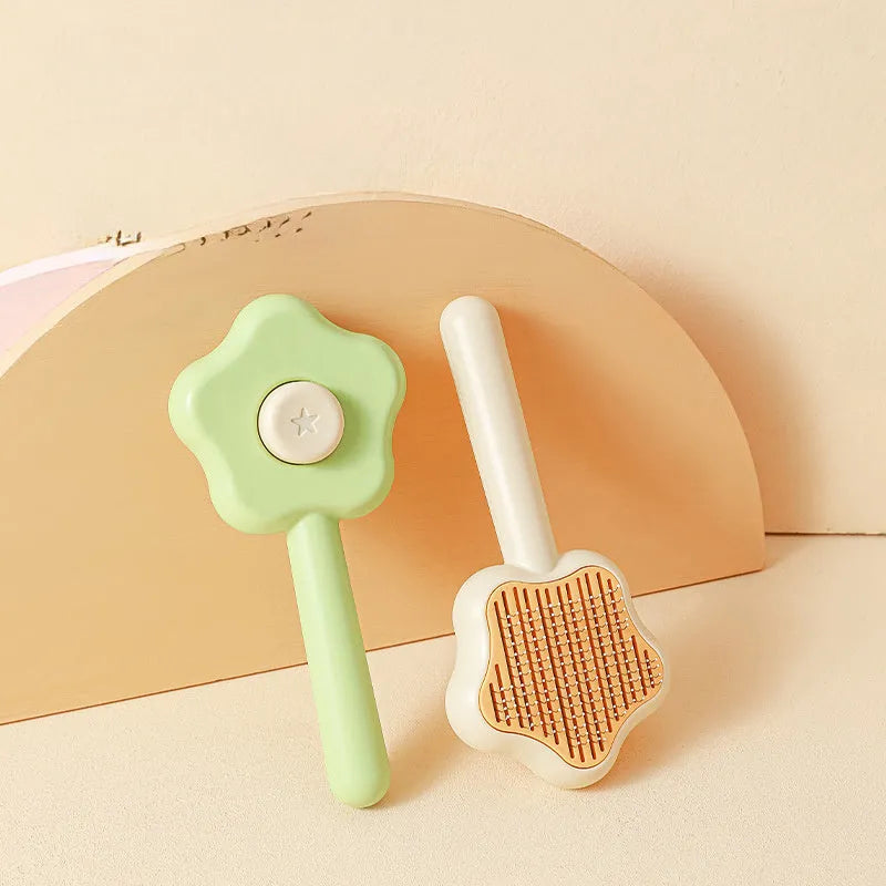 Self-cleaning stainless steel cat comb magic wand measuring 20cm with green or yellow colour options