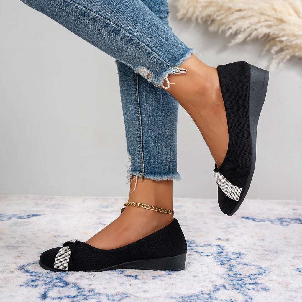 Black women's slip-on casual shoes with a chunky heel and rhinestone decoration on the fabric upper.